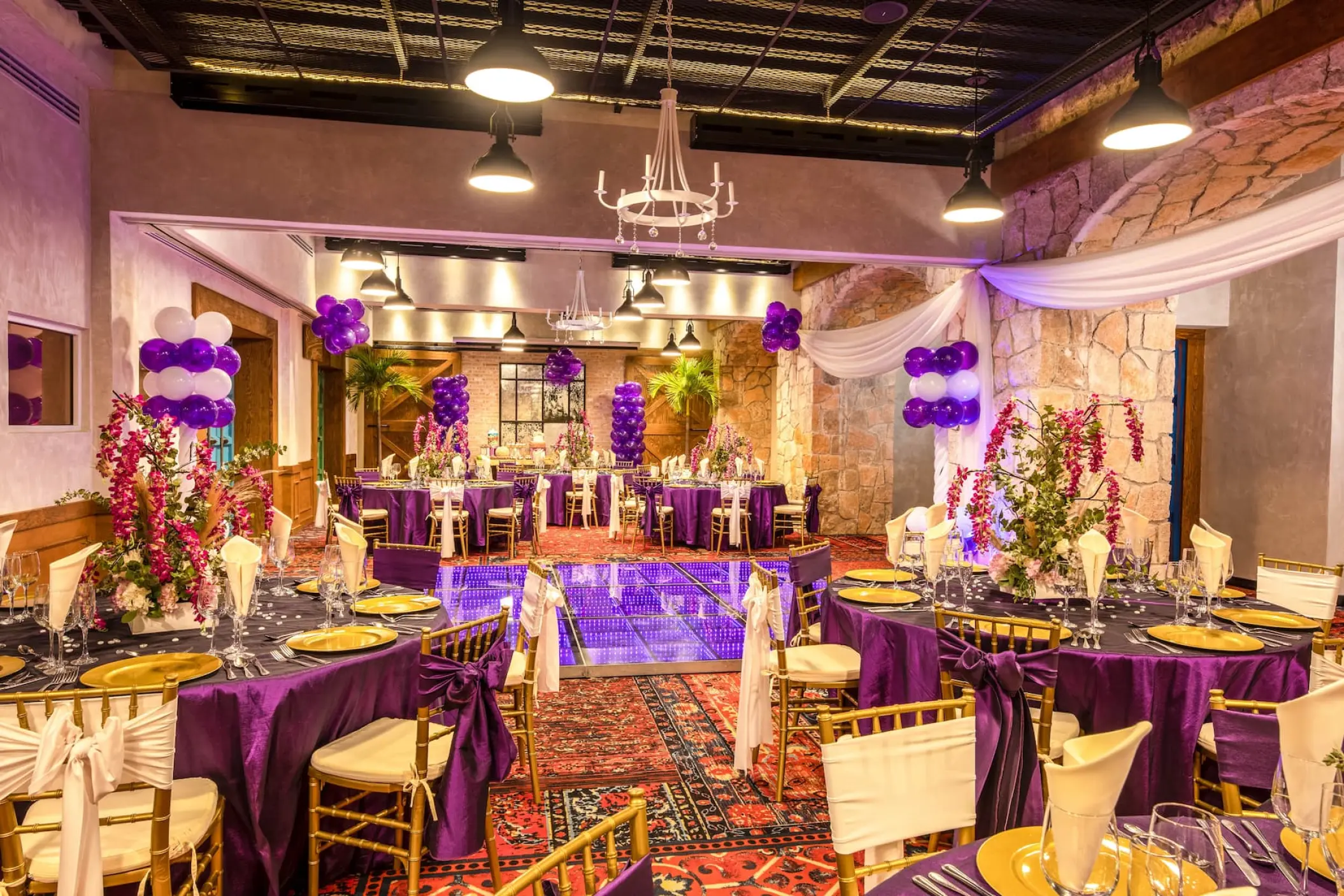 Indoor wedding reception with purple linens and a dance floor at Wyndham Alltra Playa del Carmen