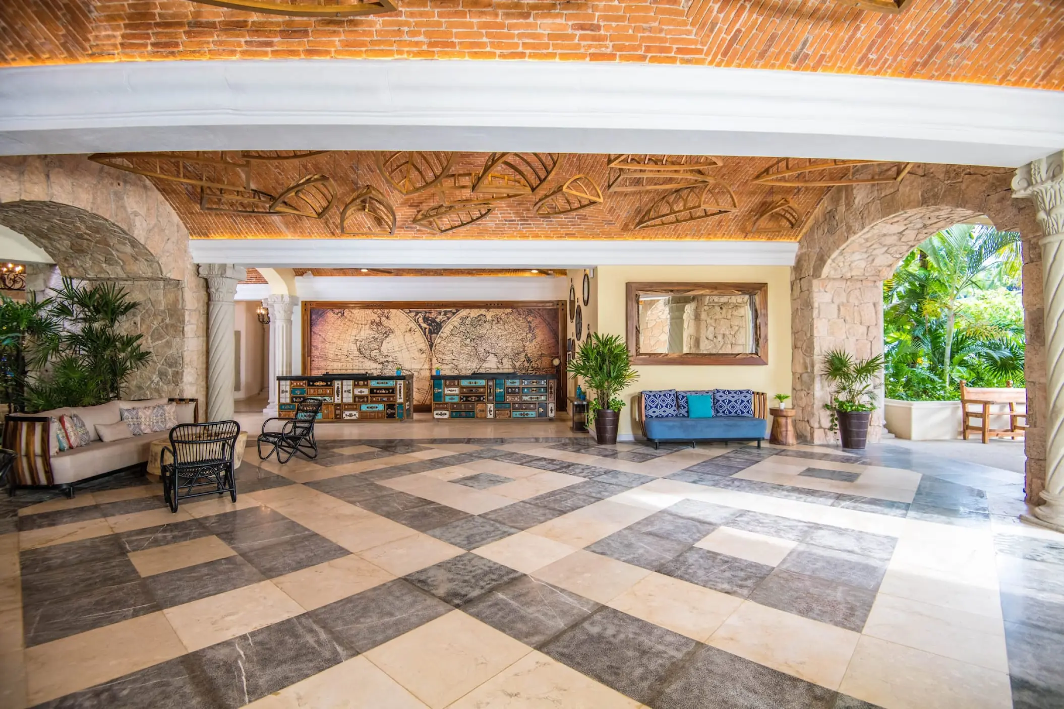 Resort lobby with arched stone entryways and vaulted brick ceiling at Wyndham Alltra Playa del Carmen