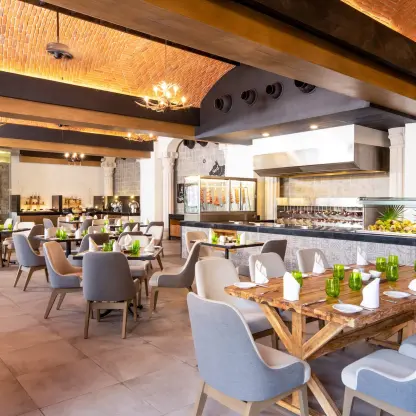 Indoor restaurant dining room with vaulted brick ceilings and buffet station at Wyndham Alltra Playa del Carmen