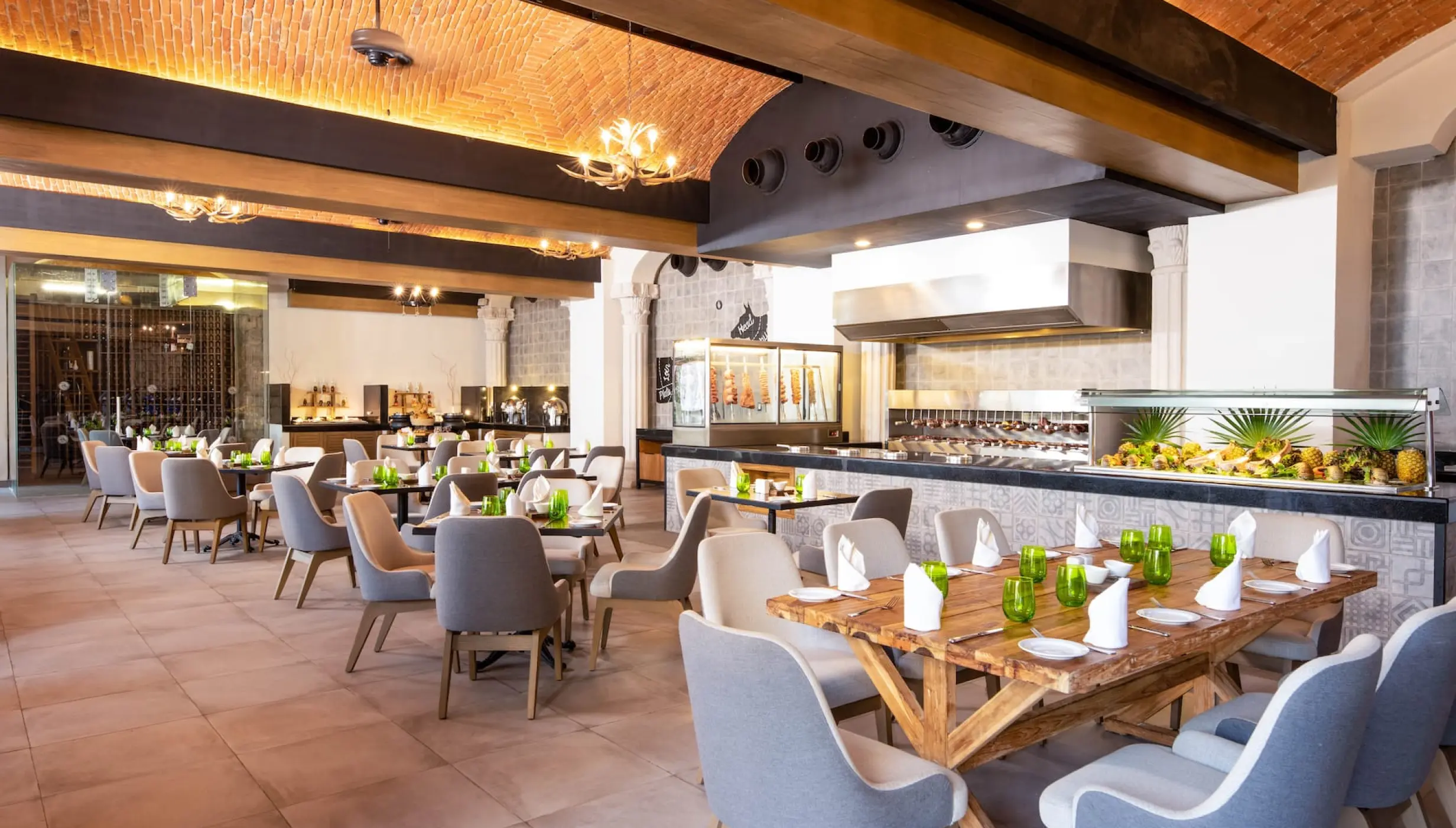 Indoor restaurant dining room with vaulted brick ceilings and buffet station at Wyndham Alltra Playa del Carmen