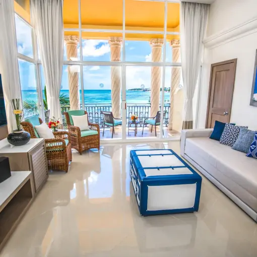 Oceanfront suite living area with balcony overlooking the Caribbean at Wyndham Alltra Playa del Carmen