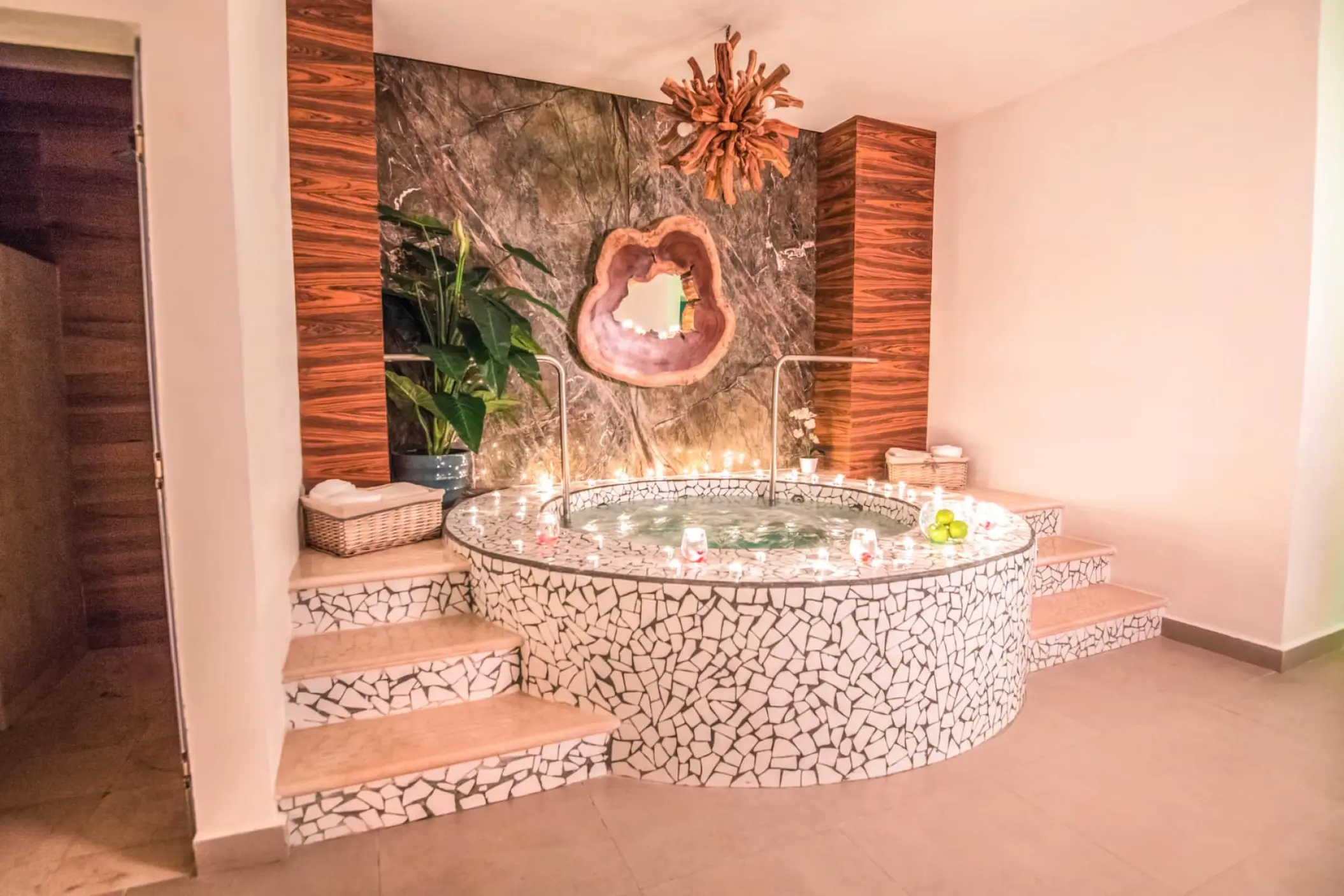 Indoor spa jacuzzi with white mosaic tiling and candlelight at Wyndham Alltra, Playa Del Carmen