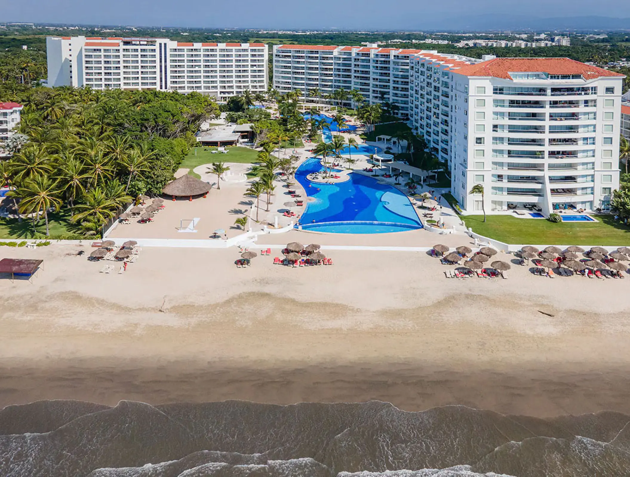 Aerial view of Wyndham Alltra Riviera Nayarit beachfront pools and guest room buildings, Puerto Vallarta