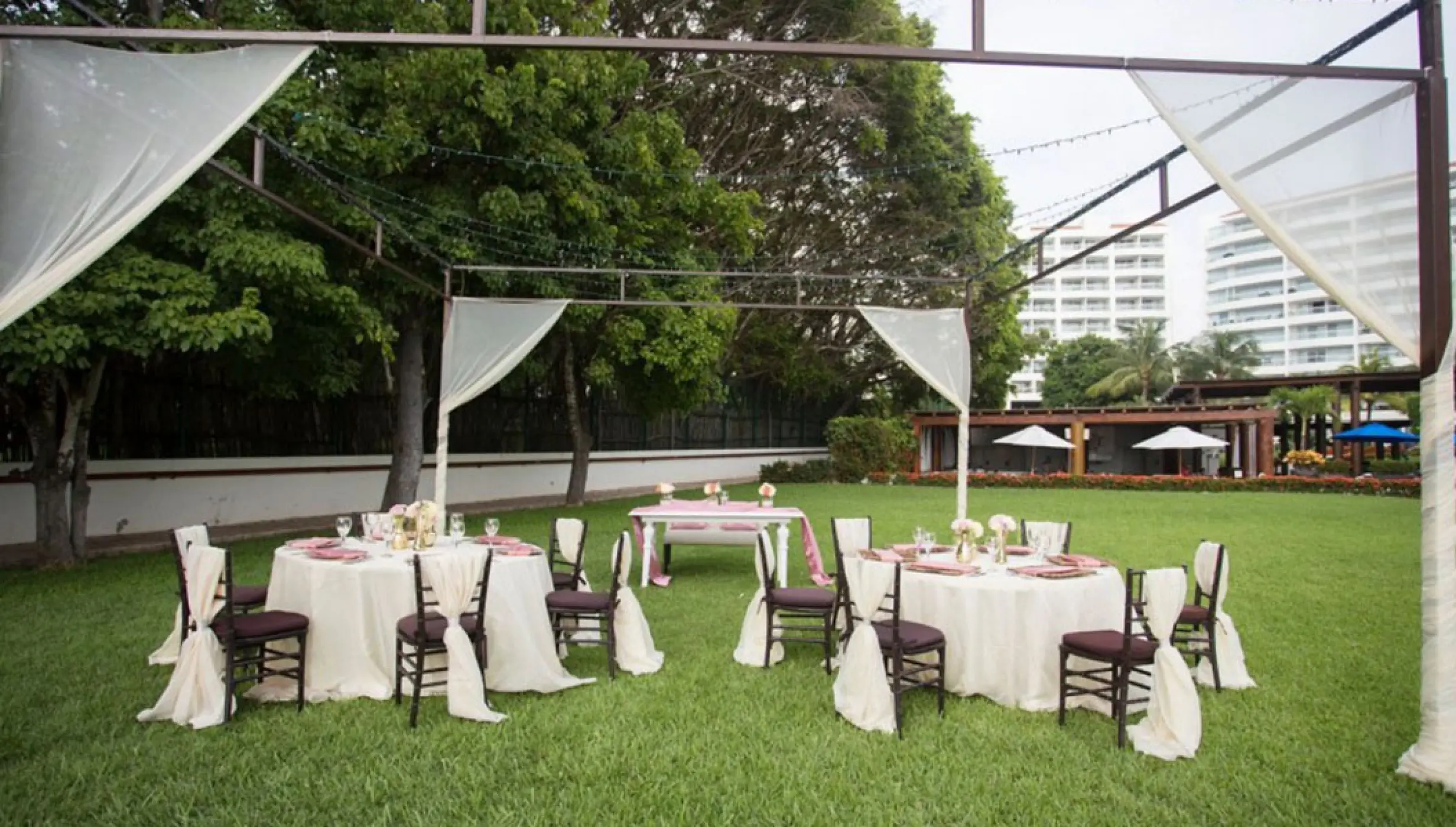 Garden wedding reception under a metal structure at Wyndham Alltra Riviera Nayarit, Puerto Vallarta