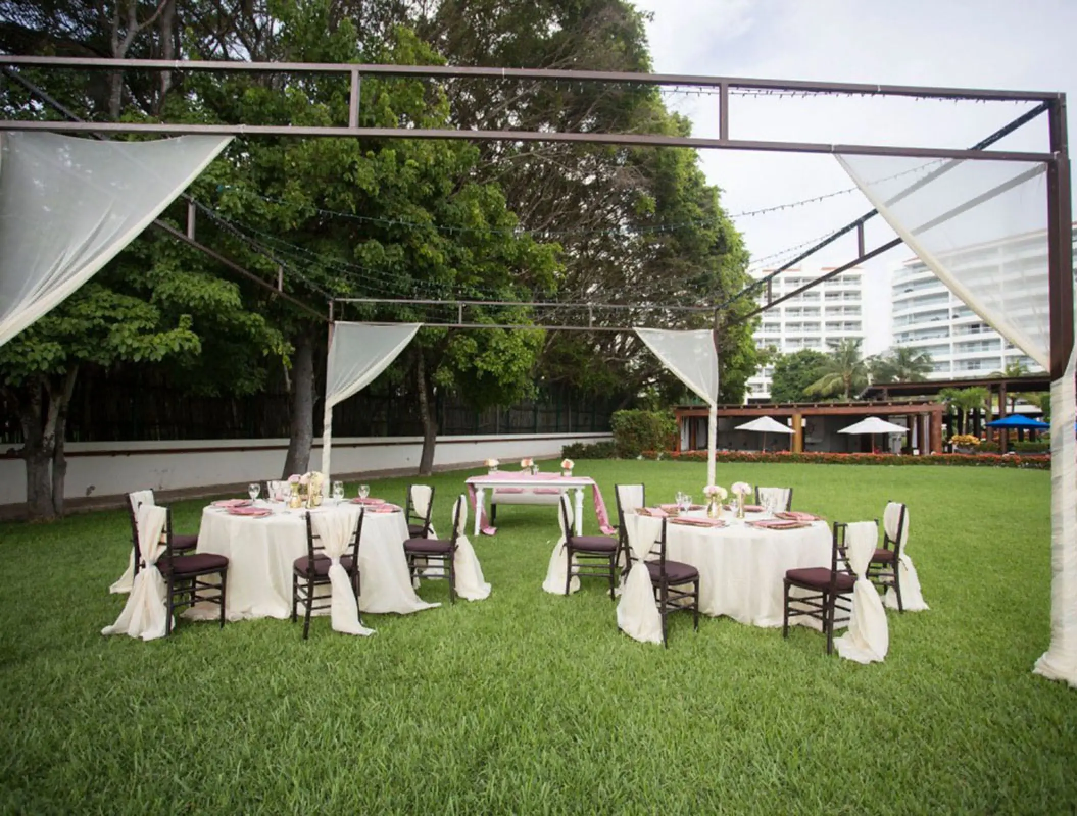 Garden wedding reception setup with draped gazebo at Wyndham Alltra Riviera Nayarit, Puerto Vallarta