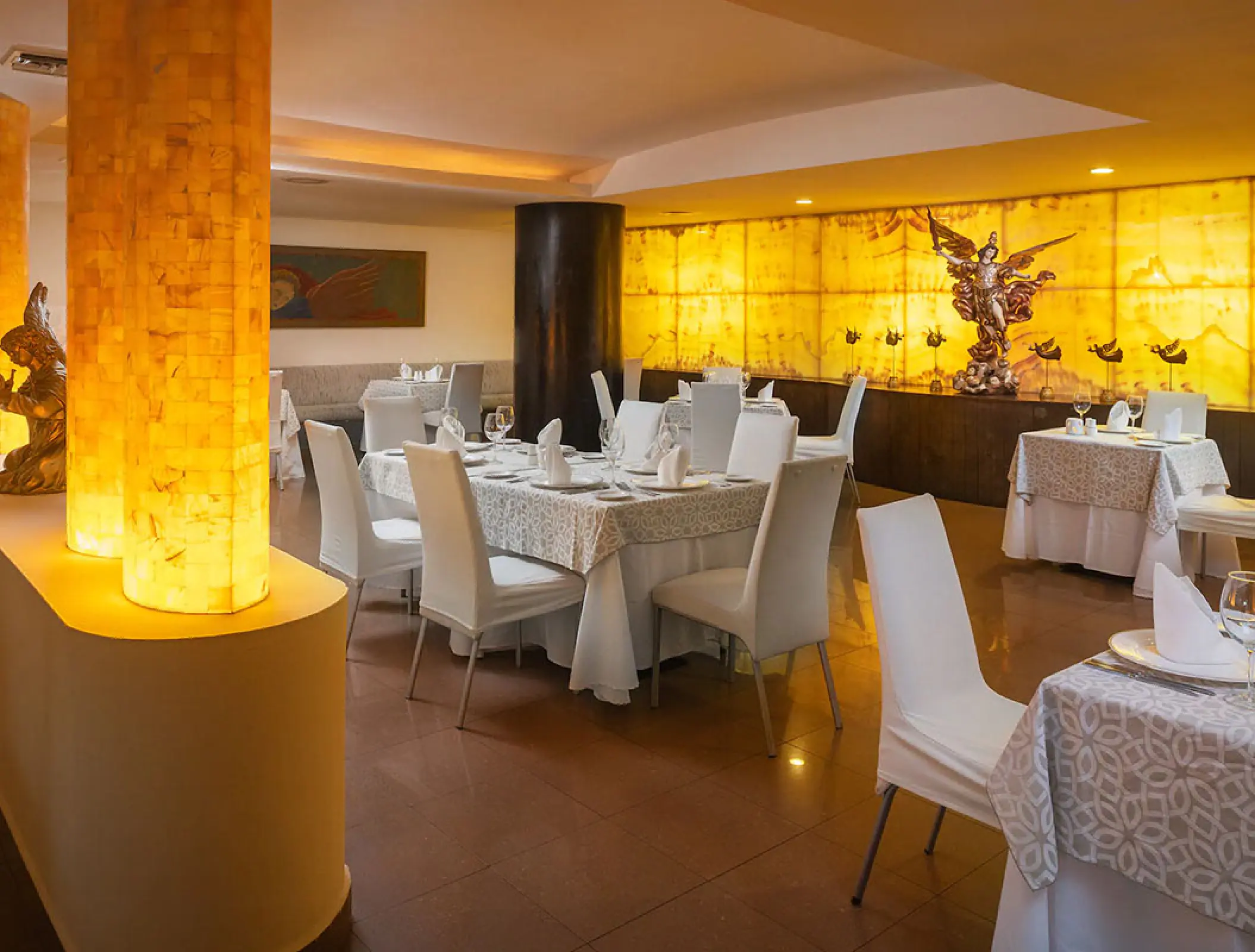 Al Dente restaurant with lit columns and set tables at Wyndham Alltra Riviera Nayarit, Puerto Vallarta