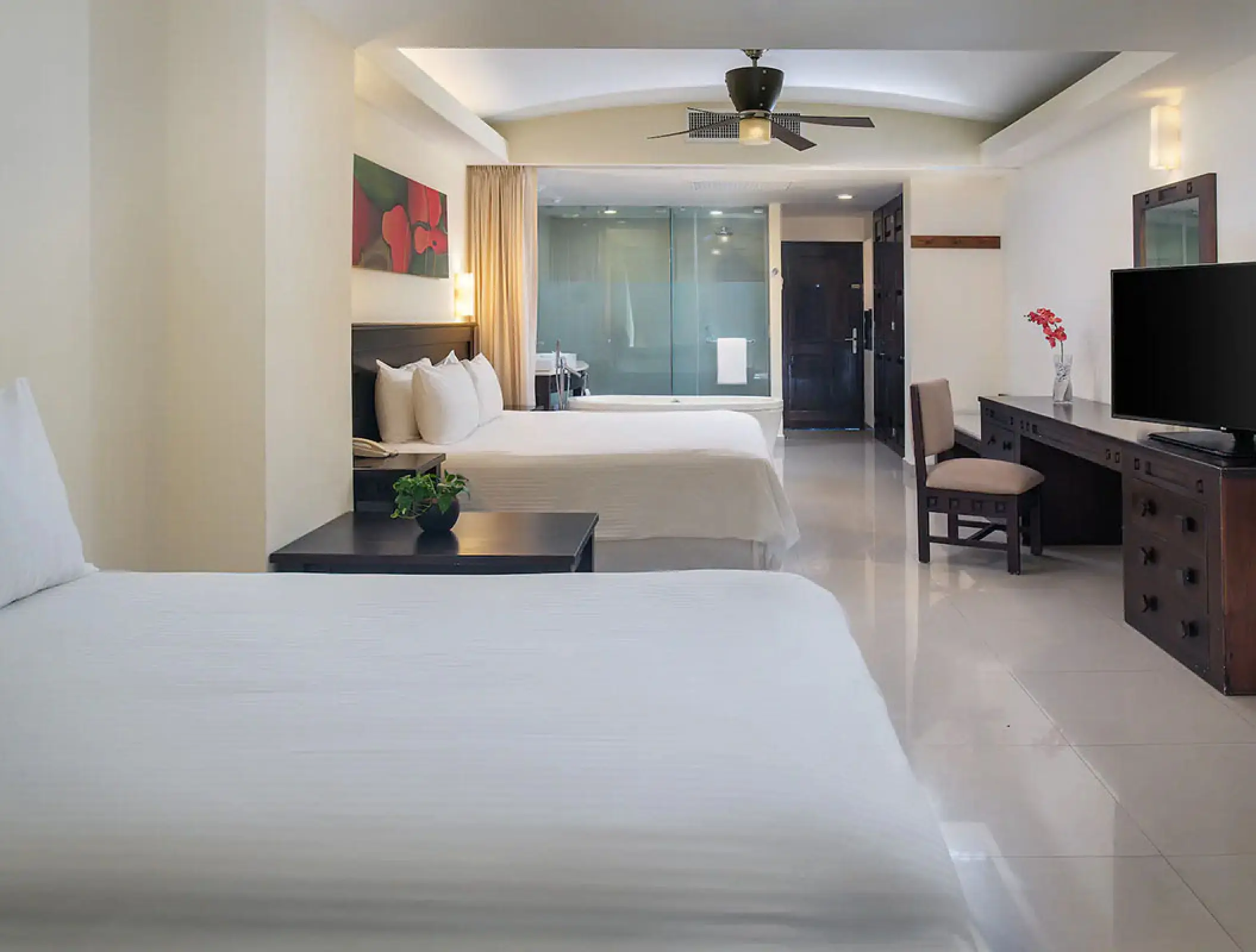 Modern suite with two double beds and a work desk at Wyndham Alltra Riviera Nayarit, Puerto Vallarta