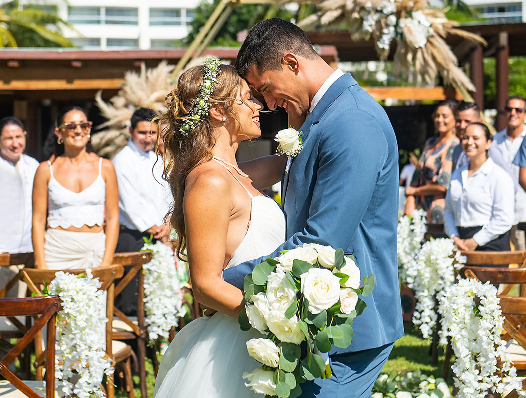 Bride and groom touching foreheads during a garden ceremony at Wyndham Alltra Riviera Nayarit, Puerto Vallarta
