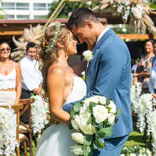 Bride and groom touching foreheads during a garden wedding ceremony at Wyndham Alltra Riviera Nayarit, Puerto Vallarta