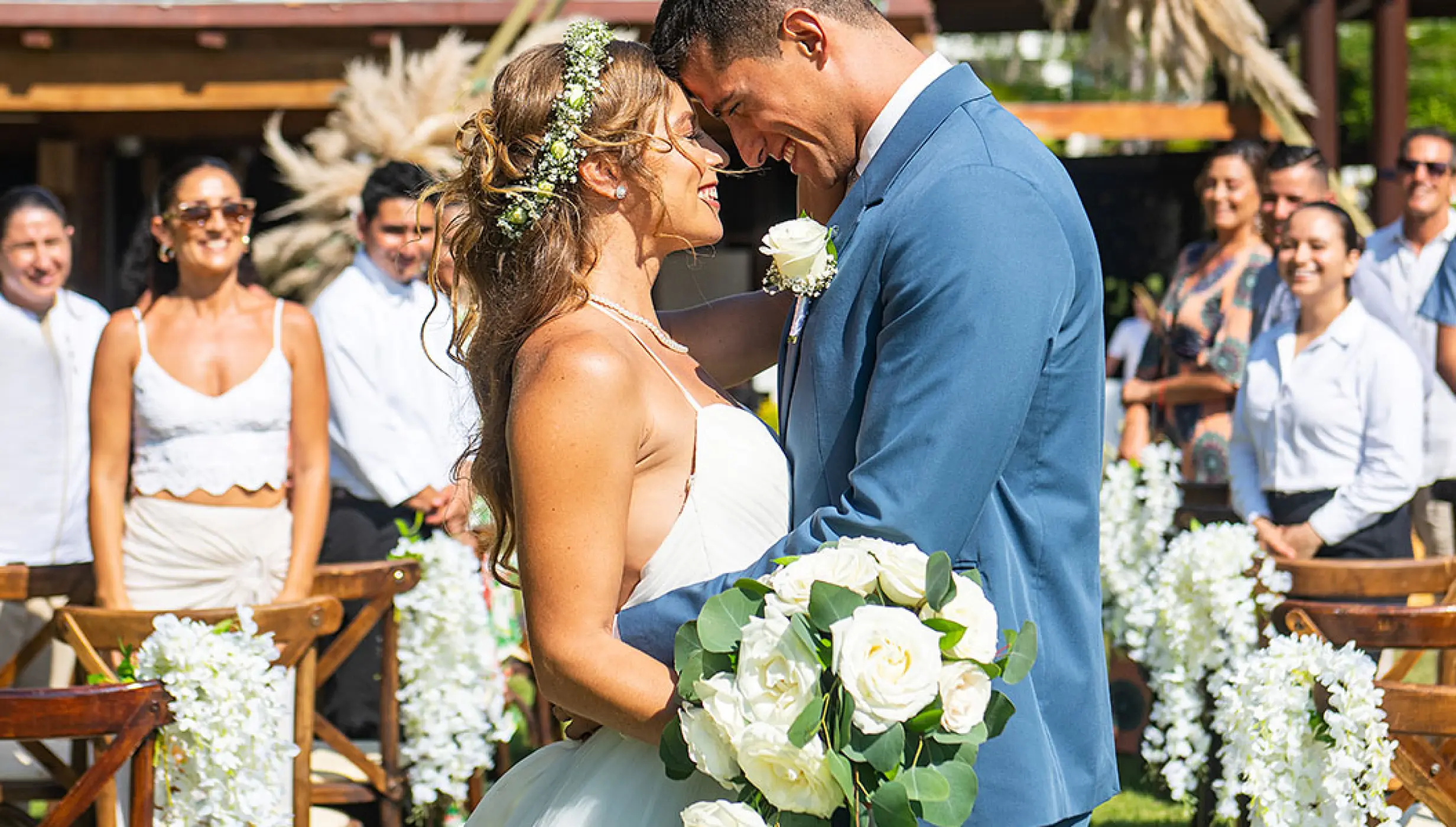 Bride and groom embrace during a garden wedding ceremony at Wyndham Alltra Riviera Nayarit, Puerto Vallarta