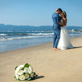 Bride and groom hugging on the beach at Wyndham Alltra Riviera Nayarit, Puerto Vallarta