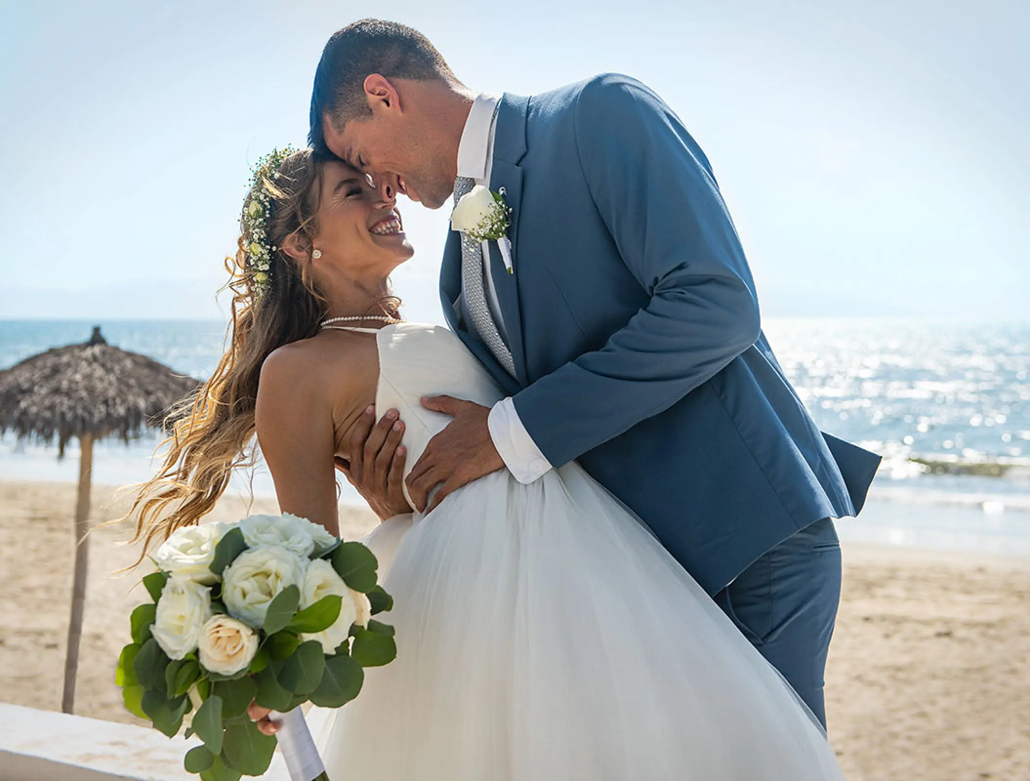 Bride and groom smiling at each other on the beach at Wyndham Alltra Riviera Nayarit, Puerto Vallarta