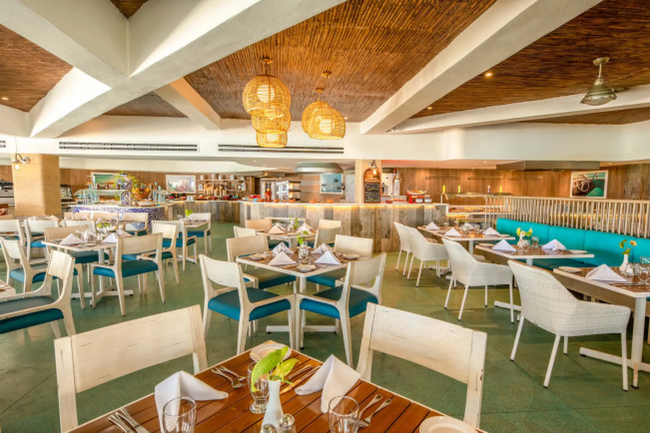 Sunscape Cancun restaurant interior with wooden tables and blue seating, Cancun