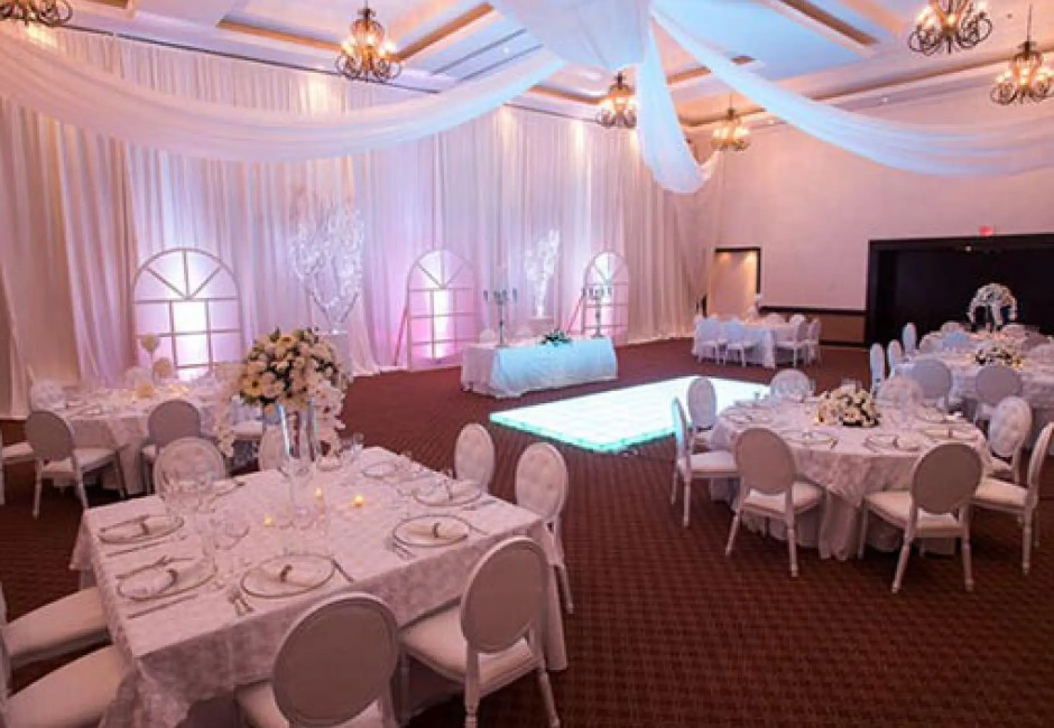 Indoor ballroom wedding reception with white drapery and dance floor at Sunscape Cancun, Cancun