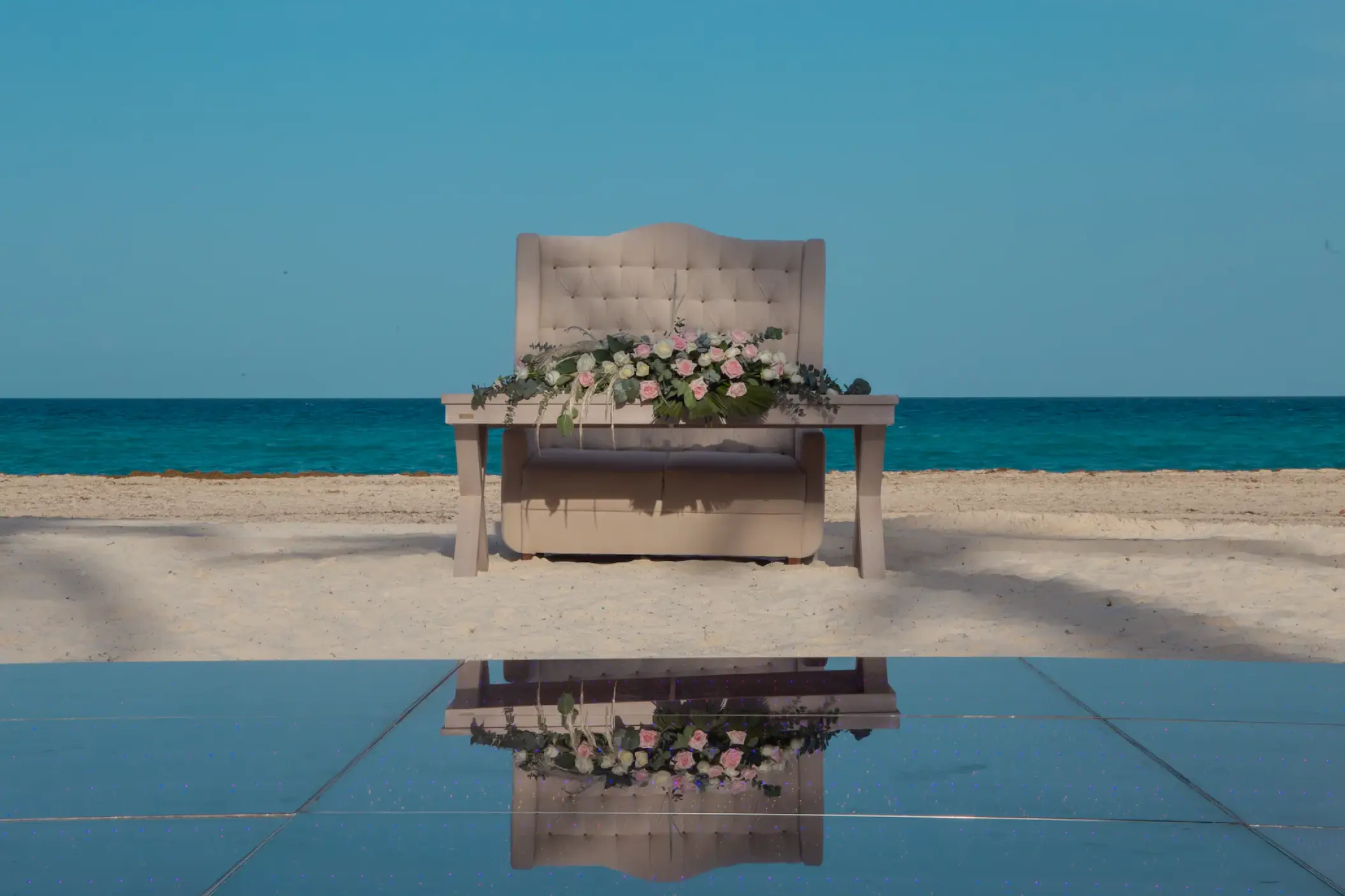 Outdoor wedding reception sweetheart table on the beach at Sunscape Cancun
