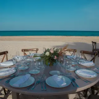 Beachfront wedding reception table with floral centerpiece at Sunscape Cancun