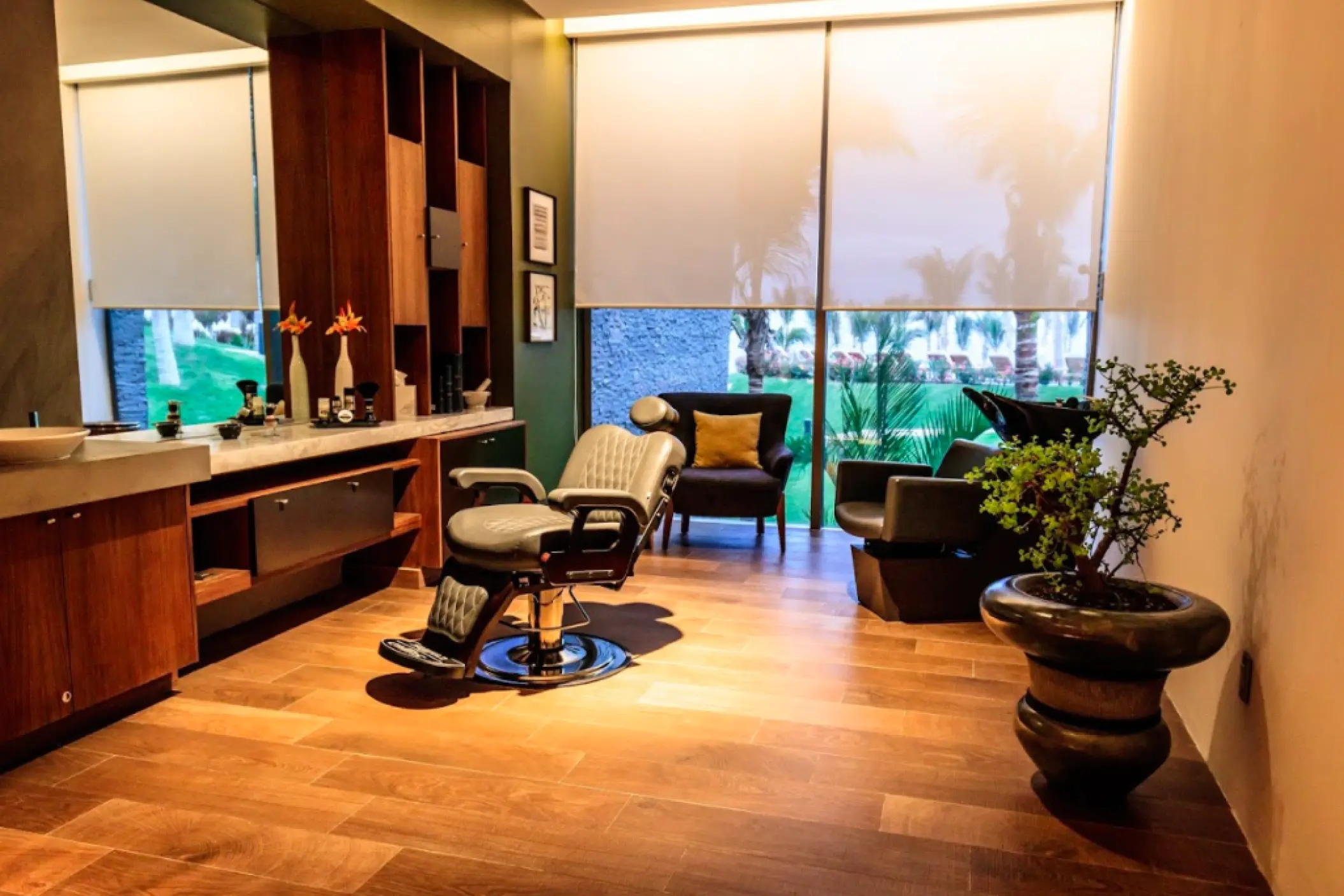 Modern barber shop with vintage leather chair and wood floors at Grand Velas Los Cabos, Cabo San Lucas