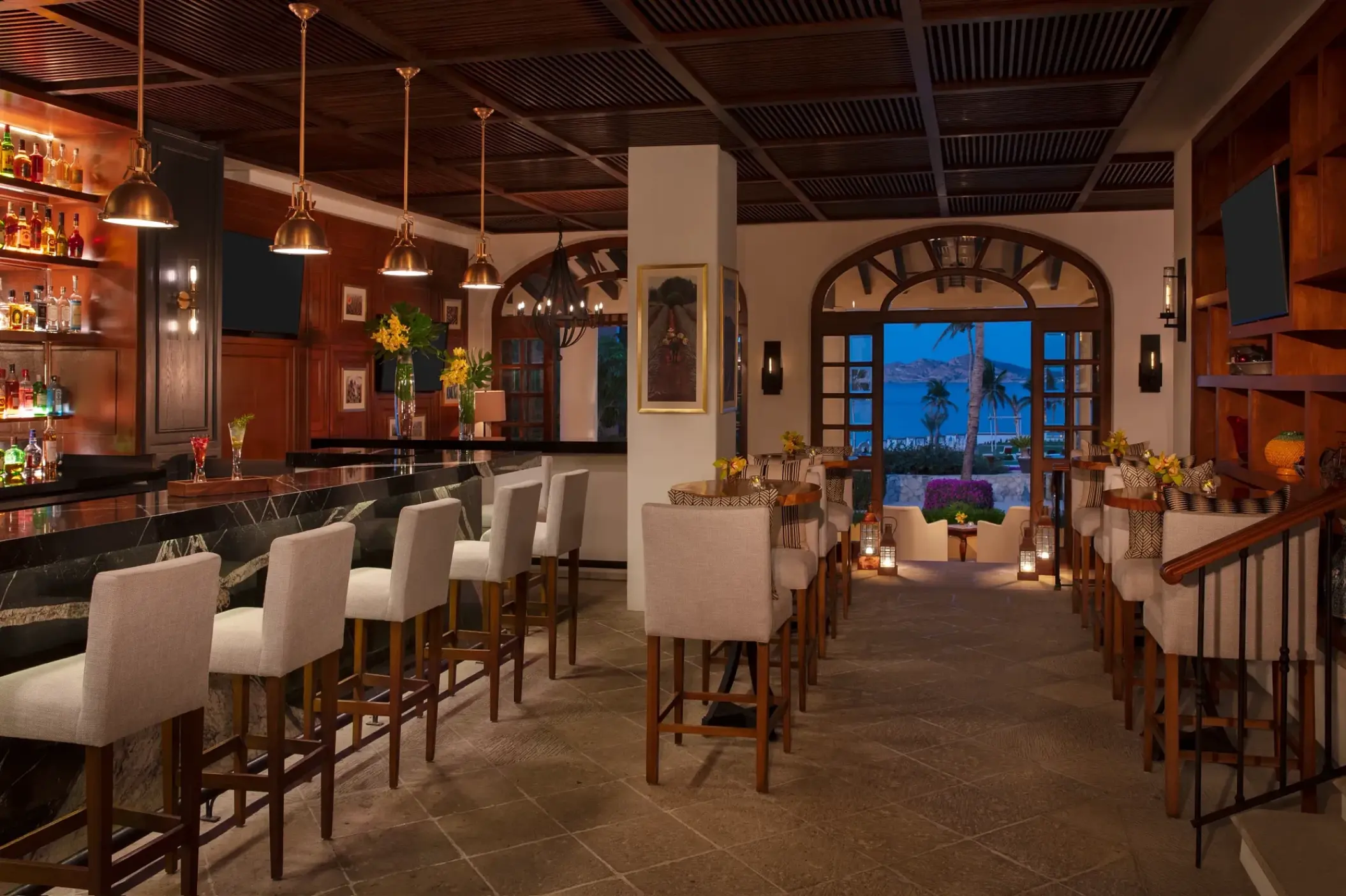 Maguey Bar with wood paneled walls and white barstools at Zoetry Casa del Mar, Cabo San Lucas