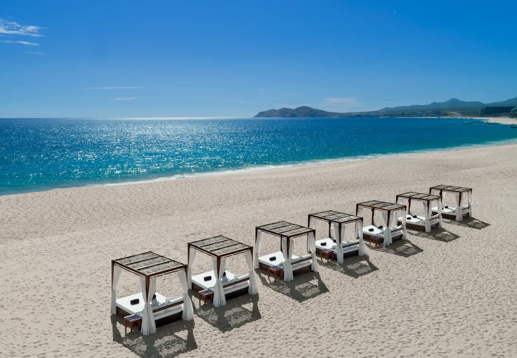 White beach cabanas on the sand at Zoetry Casa del Mar, Cabo San Lucas
