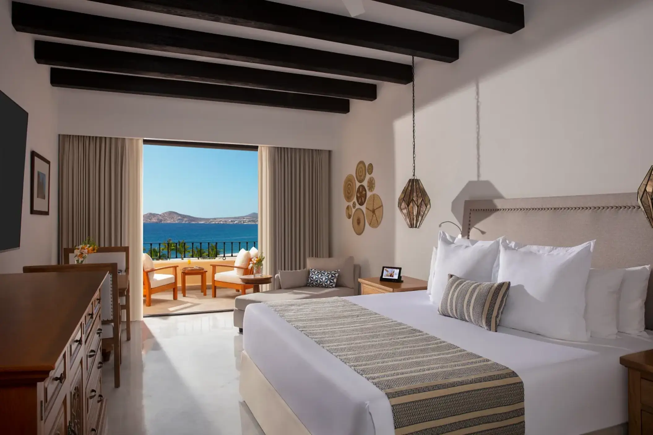 Junior suite with ocean views and dark wood ceiling beams at Zoetry Casa del Mar, Cabo San Lucas