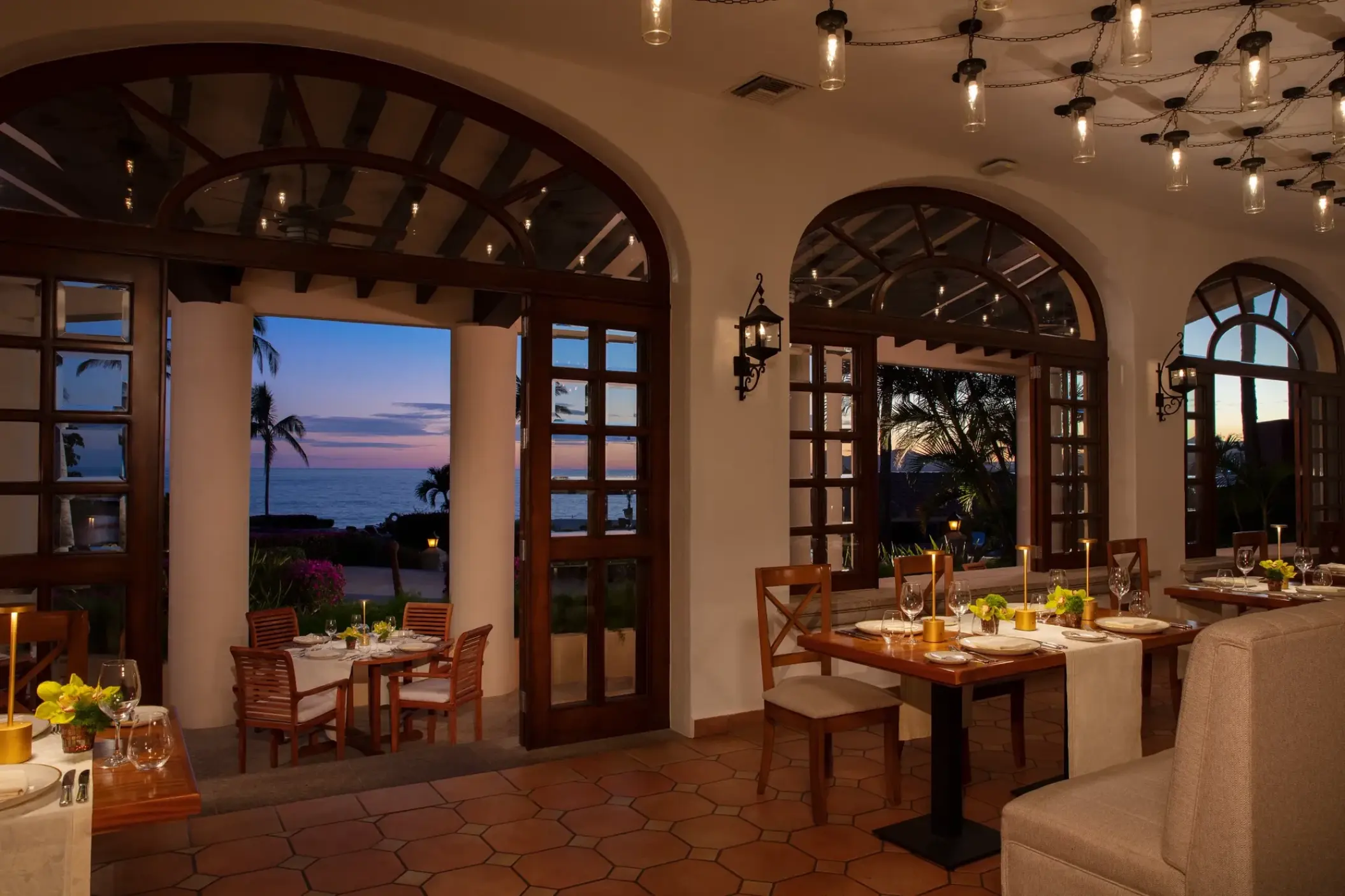 Zoetry Casa del Mar restaurant with arched doorways and ocean views at sunset, Cabo San Lucas