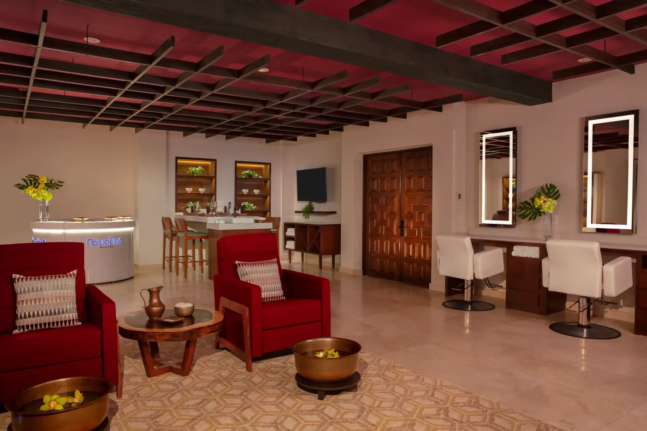 Spa lounge and salon with red armchairs and light-up mirrors at Zoetry Casa del Mar, Cabo San Lucas