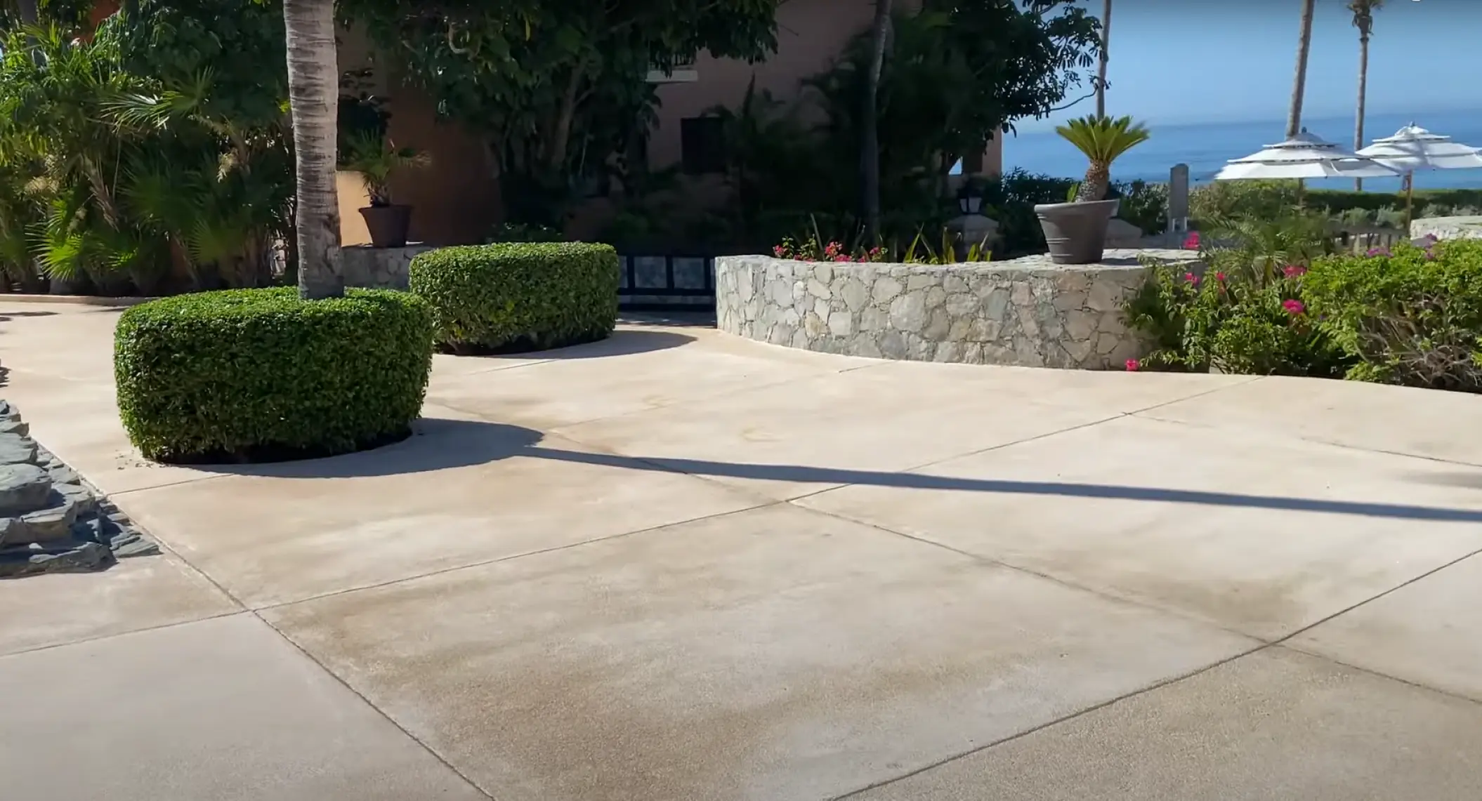 Paved terrace with stone walls and tropical greenery at Zoetry Casa del Mar, Cabo San Lucas