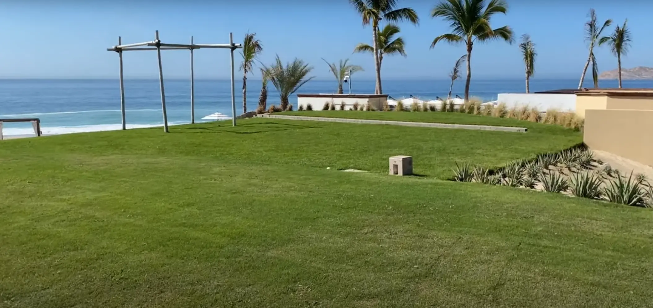 Oceanfront wedding ceremony lawn with a wooden huppah at Zoetry Casa del Mar, Cabo San Lucas
