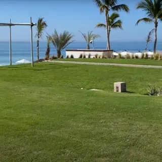 Oceanfront wedding ceremony lawn with a wooden huppah at Zoetry Casa del Mar, Cabo San Lucas