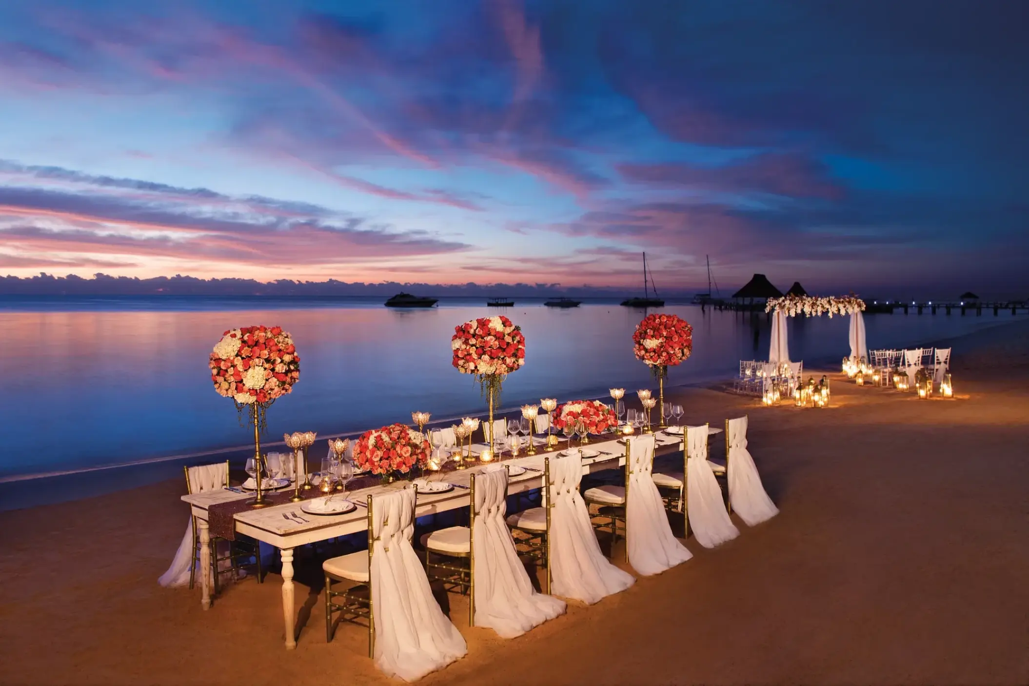Beachfront wedding reception setup with floral centerpieces at Zoetry Paraiso de la Bonita, Riviera Maya