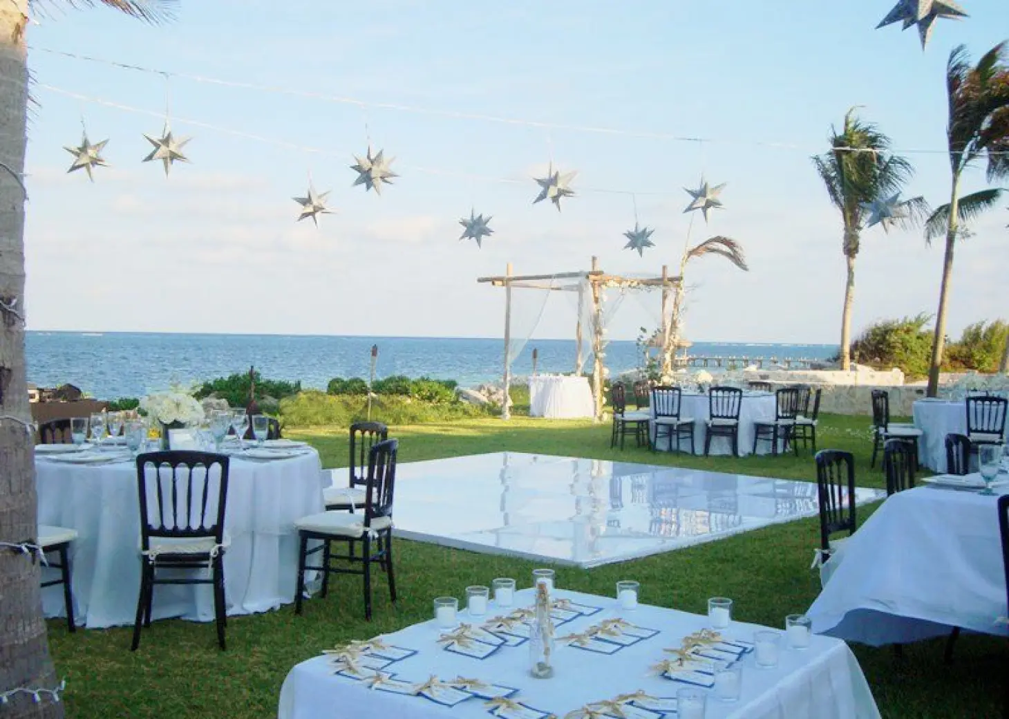 Outdoor wedding reception with a white dance floor on the lawn at Zoetry Paraiso de la Bonita, Riviera Maya