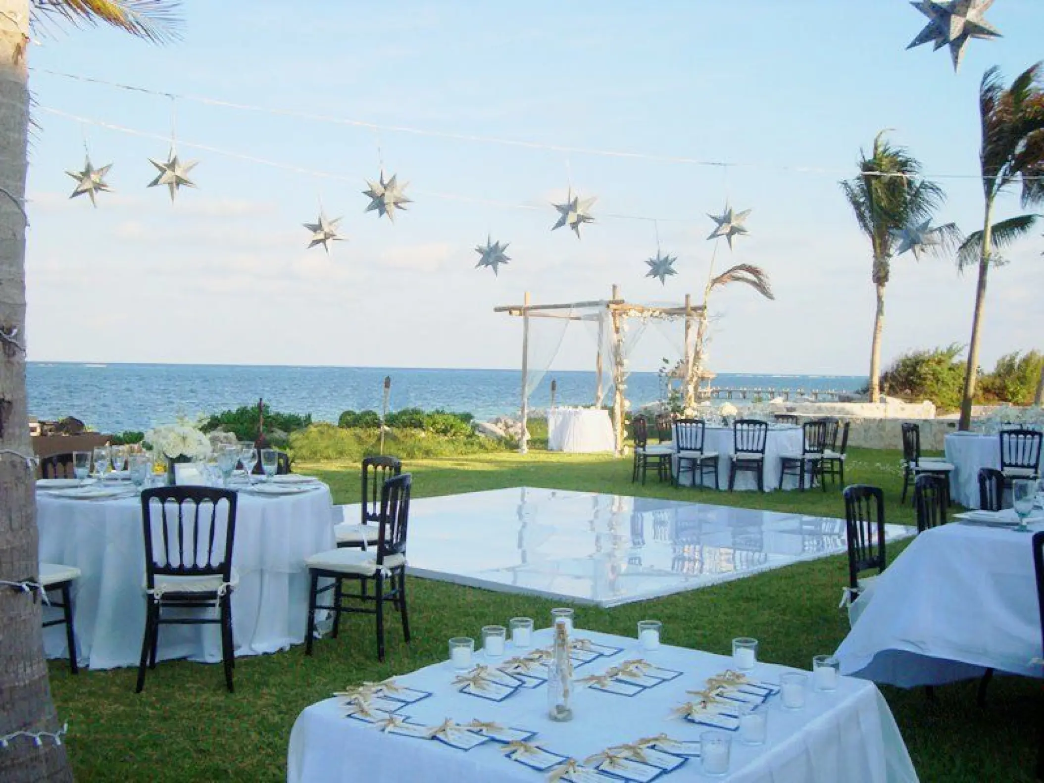 Outdoor wedding reception with a white dance floor on the lawn at Zoetry Paraiso de la Bonita, Riviera Maya