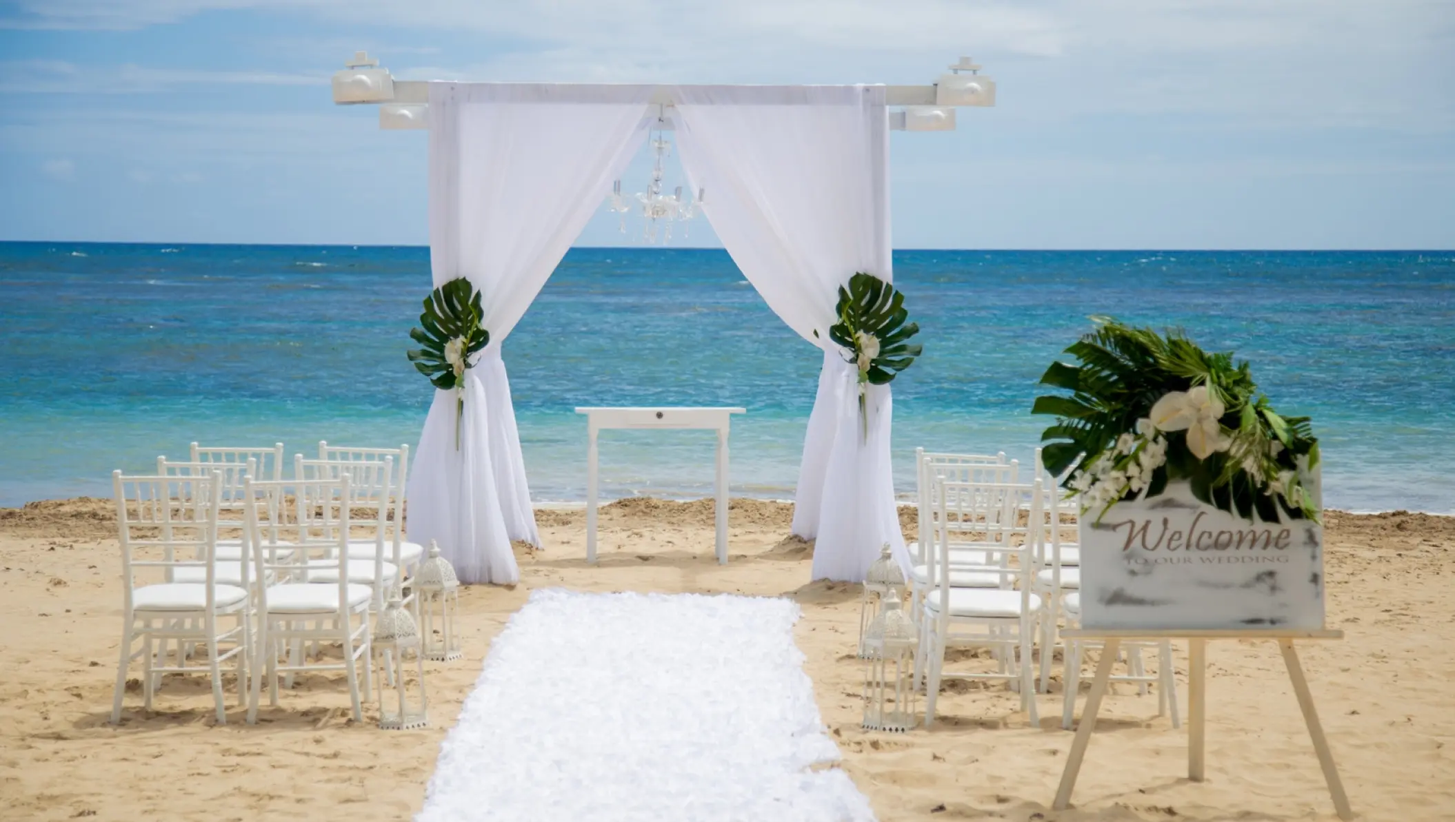Beachfront wedding ceremony with white gazebo and chairs at Zoetry Agua, Punta Cana