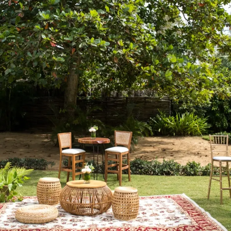 Outdoor cocktail hour lounge with woven furniture and tall bistro tables at Zoetry Agua, Punta Cana