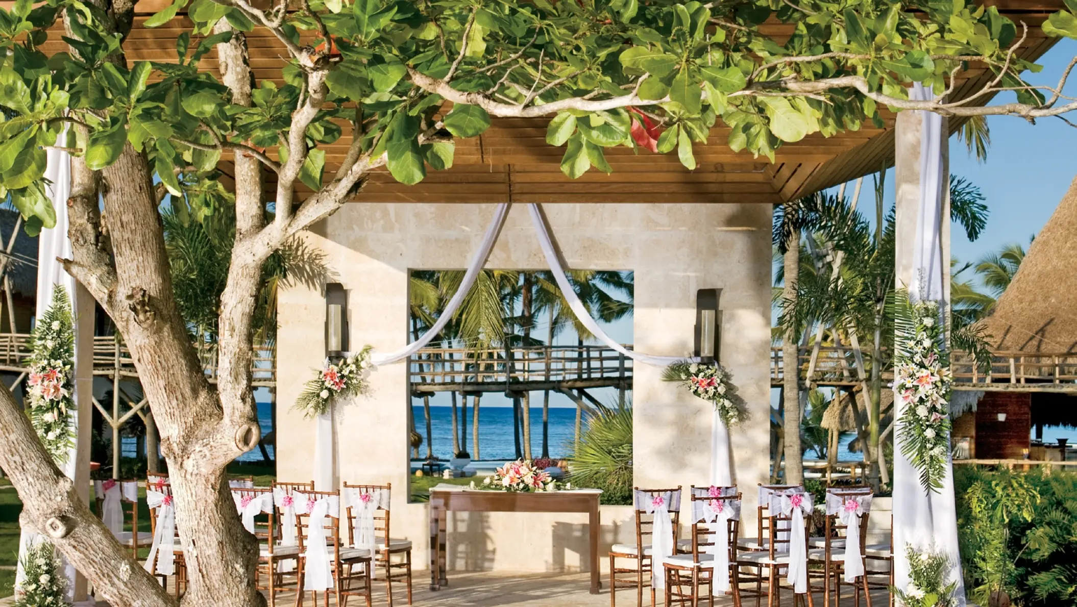 Stone gazebo wedding ceremony setup with ocean views at Zoetry Agua, Punta Cana