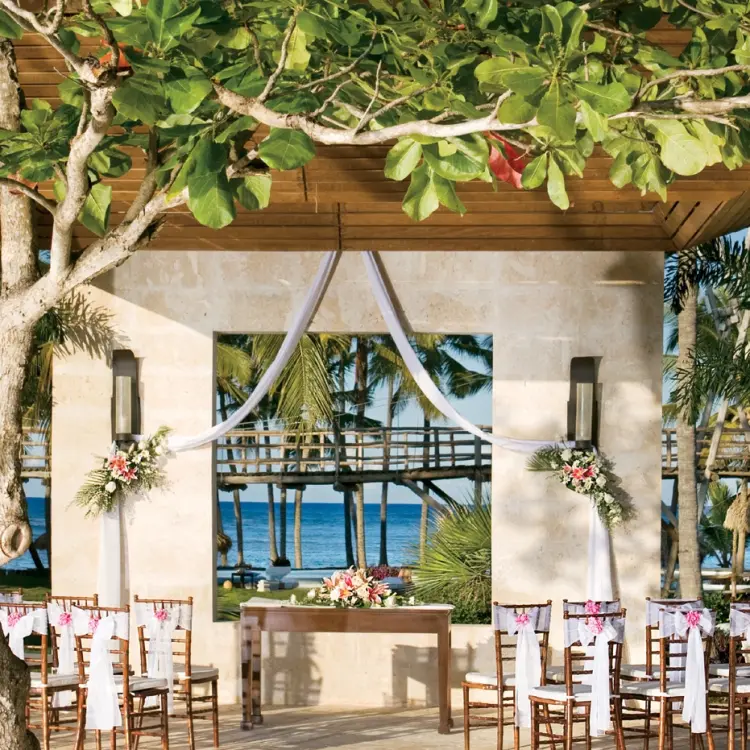 Stone gazebo wedding ceremony setup with ocean views at Zoetry Agua, Punta Cana