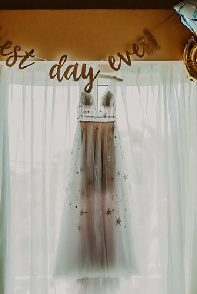 bridal dress hanging on window