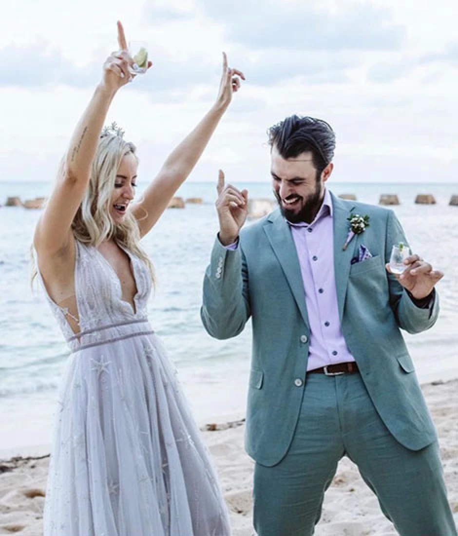 Newlyweds have fun on the beach