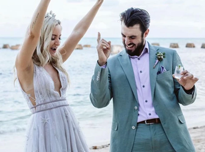 Newlyweds have fun on the beach