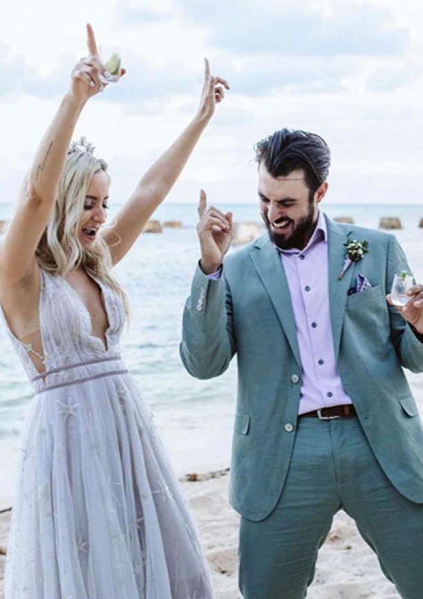 Newlyweds have fun on the beach