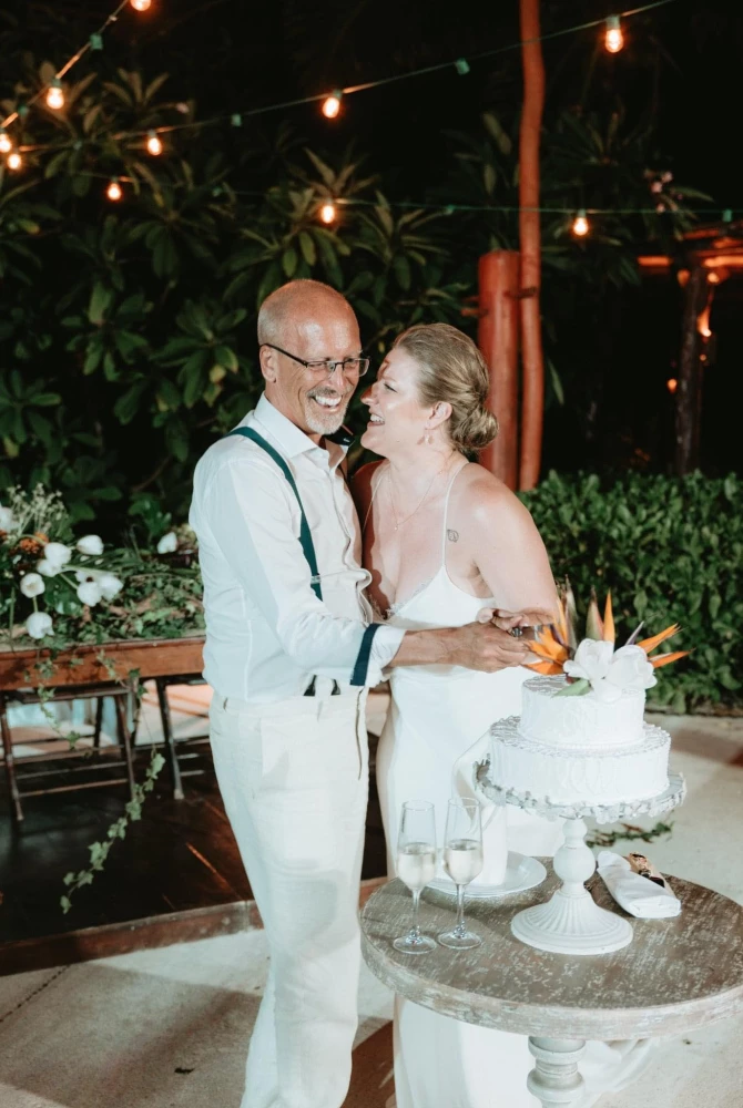 groom and bride cuts cake