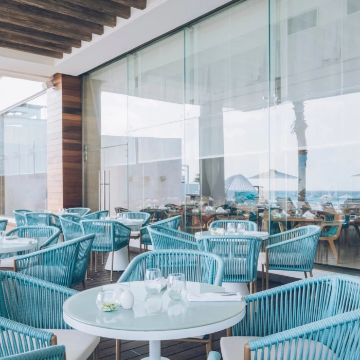 Coral Level Iberostar Cancun outdoor restaurant blue seating