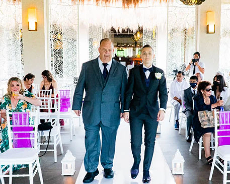 groom walking down the isle with his father