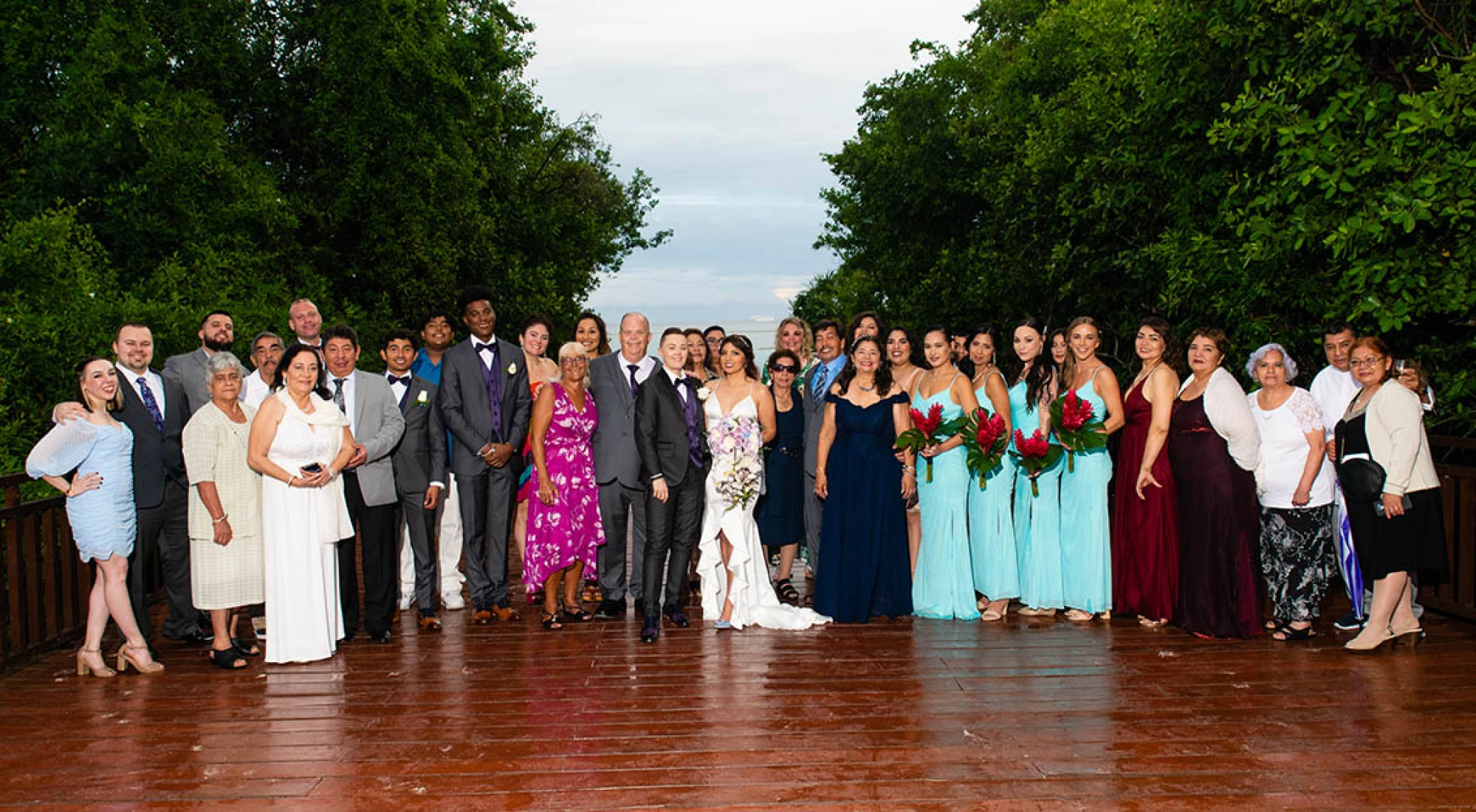 wedding group photo at a tropical deck