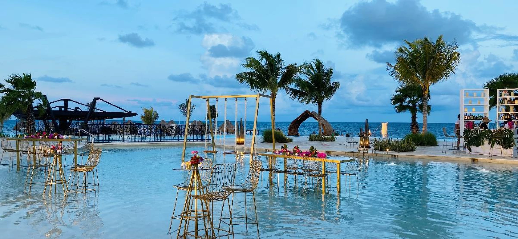 Cocktail hour decor in Bluewater shallow pool wedding venue at Dreams Natura Resort and Spa