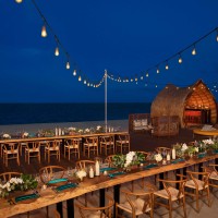 Beach wedding reception with table and chairs at Dreams Natura Resort and Spa