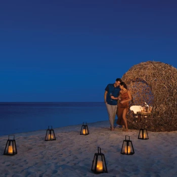 couples romantic supper on beach at Dreams Natura Resort and Spa