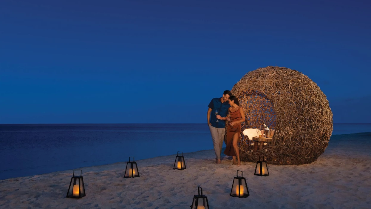 couples romantic supper on beach at Dreams Natura Resort and Spa