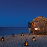 couples romantic supper on beach at Dreams Natura Resort and Spa