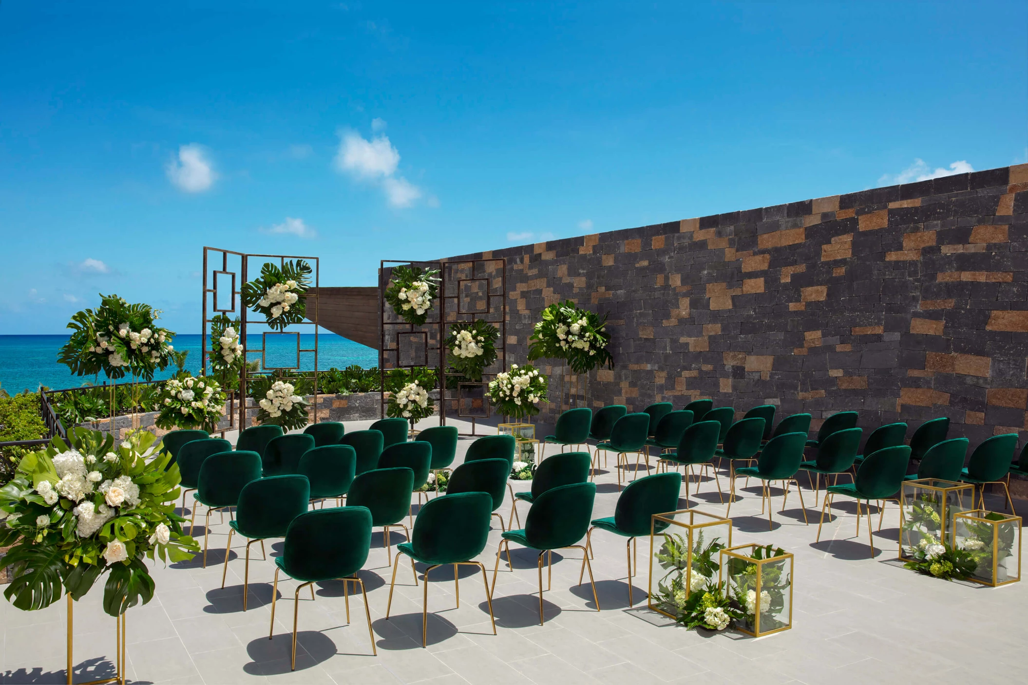 Wedding terrace with green chairs and altar at Dreams Natura Resort and Spa